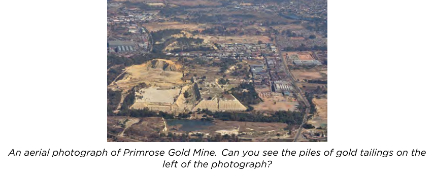 An aerial photograph of Primrose Gold Mine, showing piles of gold tailings.